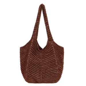 Dark brown knit tote bag with chevron texture and wide shoulder strap for autumn