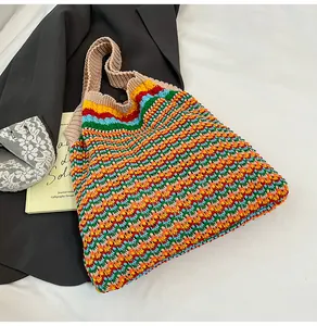 Detail of colorful knit tote bag featuring rainbow stripes and soft crochet texture