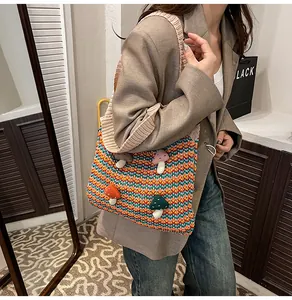 Detail view of multi-color striped crochet tote bag with 3D mushroom patches and wide strap
