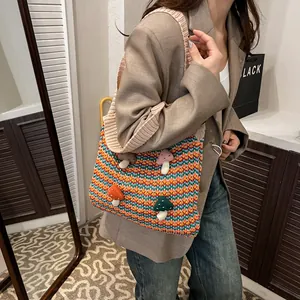 Colorful knitted tote bag with 3D mushroom accents and vibrant striped crochet patterns