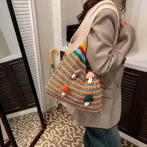 Striped knit tote bag with mushroom appliques and wide shoulder strap shown on model