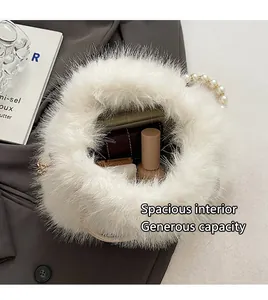 Top-down view of white faux fur bucket bag showing interior space for small essentials
