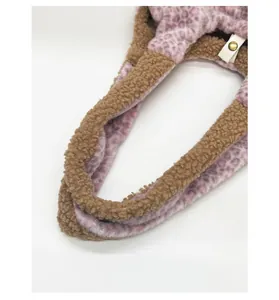 Detail of plush tote bag with brown faux fur exterior and pink leopard print lining
