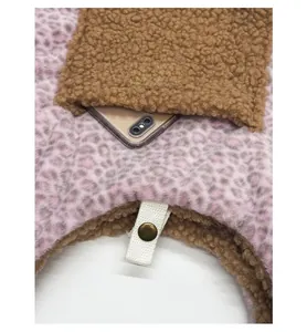 Macro detail of plush leopard tote bag featuring multi-layer pockets and snap button closure