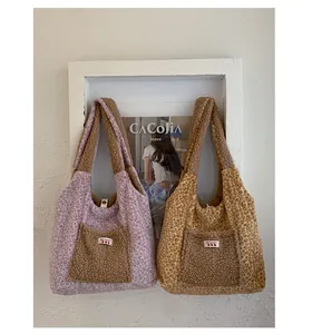 Detail of plush leopard print tote bags with front pockets and YES HONEY woven labels