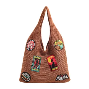 Brown knit tote bag with cryptozoology embroidered patches like Bigfoot and Mothman