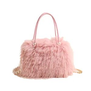 Pink faux fur handbag with elegant pearl accents and a stylish golden chain strap