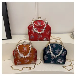 Detail of vintage Chinese embroidery bags with floral patterns and pearl bead handles