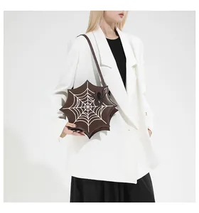 Detail of Gothic spider web shoulder bag featuring star shape and 3D spider ornament