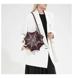 Detailed close-up of dark red spider web embroidery on a star-shaped gothic bag