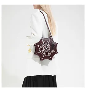 Macro detail of gothic burgundy spider web shaped shoulder bag on a white blazer
