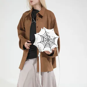 Gothic white spider web shoulder bag with black embroidery shown on a model