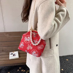 New Chinese shell bag in red brocade with pearl handle and floral horse pattern