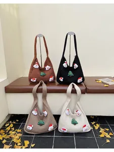 Close-up of knitted tote bags with Santa and Christmas tree patches in four colors