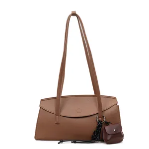 Elegant brown pebble leather tote bag with curved flap and matching mini coin purse charm