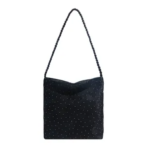 Minimalist black polka dot shoulder bag with woven rope handle for casual daily wear