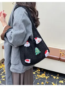 Detail of black knit shoulder bag featuring 3D Santa Claus and Christmas tree patches