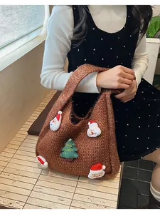 Detail of brown knit shoulder bag with Santa Claus and Merry Christmas tree charms