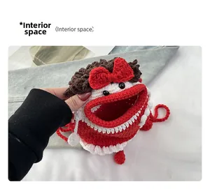 Interior space of a handmade crochet monster bag with red lips and knitted texture