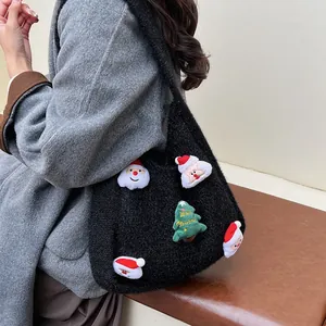 Black plush knit underarm bag featuring festive Christmas embroidery and Santa patches