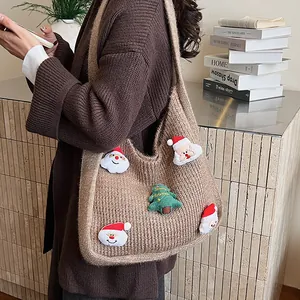 Brown knit hobo shoulder bag with Santa and Christmas tree patches on model