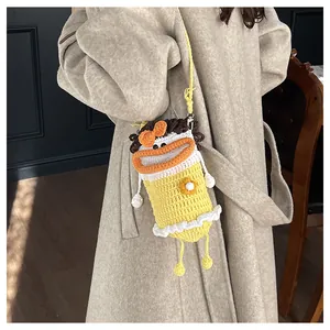 Detailed knit cross-body bag showing hand-woven cartoon duck pattern and soft texture