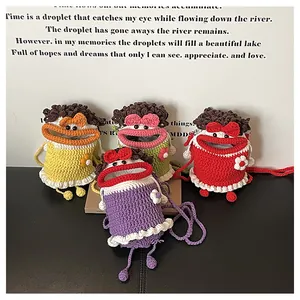 Detail of colorful knit bucket bags featuring monster faces with big lips and bowties