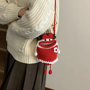 Handmade knitted bucket bag with cute red cartoon character and crossbody strap