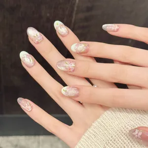 Handmade cherry blossom press-on nails with pink gradient cat-eye finish and French tips