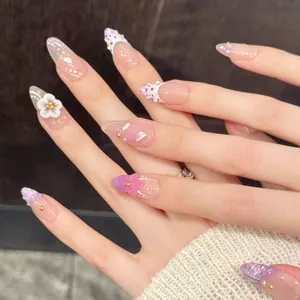 Pink and purple gradient press-on nails with 3D floral accents and glitter details