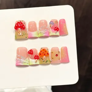 Handmade 3D mushroom press-on nails with pink green gradient and butterfly charms