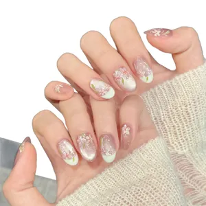 Handmade almond press-on nails featuring cherry blossom art and cat eye glitter finish