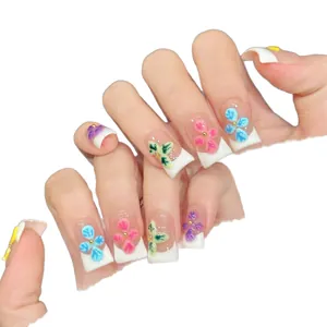 Short square press-on nails with white French tips and 3D floral relief decorations