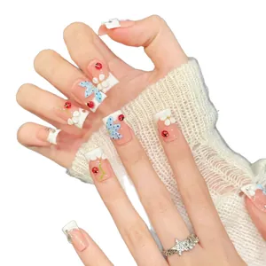 Short square press-on nails with 3D ladybugs, white flowers and blue bows on pink base