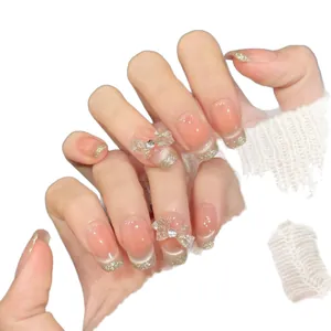 Rosa Ombre Kunstnägel mit goldenen French-Glitzer Spitzen und 3D-Schleifen Deko