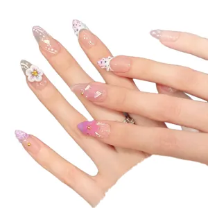 Pink and purple long almond press-on nails with 3D floral petals and golden beads
