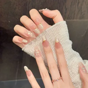 Almond shaped cream camellia press-on nails with 3D floral carving and pearl accents