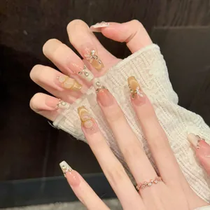 Pink gradient press-on nails with golden butterfly, cat eye effect and 3D pearls