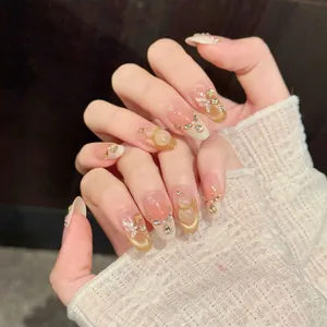 Pink gradient almond press-on nails with golden butterfly, pearls and rhinestone accents