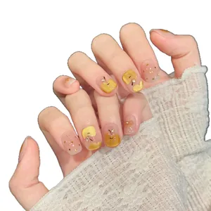 Handmade press-on nails with hand-painted gold apple designs and gold foil accents