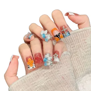 Duckbill style press-on nails with 3D bows, lollipop charms, and rhinestone accents