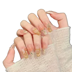 Pink gradient press-on nails with 3D butterfly, pearls, and rhinestones in coffin shape