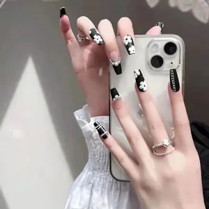 Handmade coffin press-on nails with black and white floral patterns and pearl details