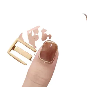 Amber glue-on nails with golden metallic edges and retro style square buckle accessory