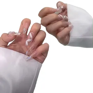 Long reusable press-on nails with white wavy patterns and aurora glitter finish