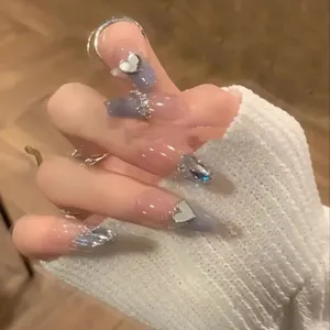 Blue and pink gradient press-on nails with silver heart charms and rhinestones