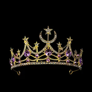 Detail of gold tiara with moon, stars, white rhinestones, and purple crystals