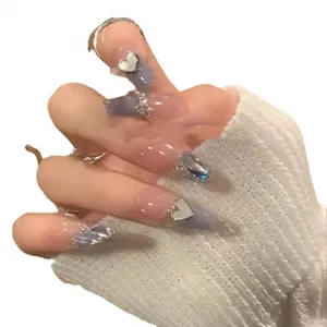 Handmade press-on nails in purple gradient with silver metal heart and glitter accents