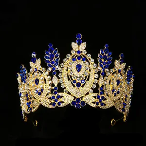 Luxurious gold baroque tiara with navy blue pear-shaped crystals and sparkling rhinestones