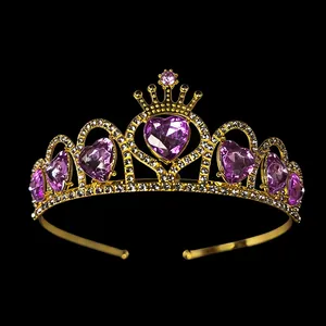 Golden princess tiara with purple heart crystals and white rhinestones on black background
